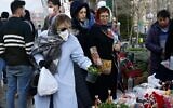 An Iranian woman wearing a protective face mask chooses traditional items ahead of Nowruz, the national New Year 2-week celebration, at the Tajrish Bazaar in the capital Tehran on March 19, 2020, despite the heavy death toll due to infections by the novel coronavirus in the country (STR / AFP)