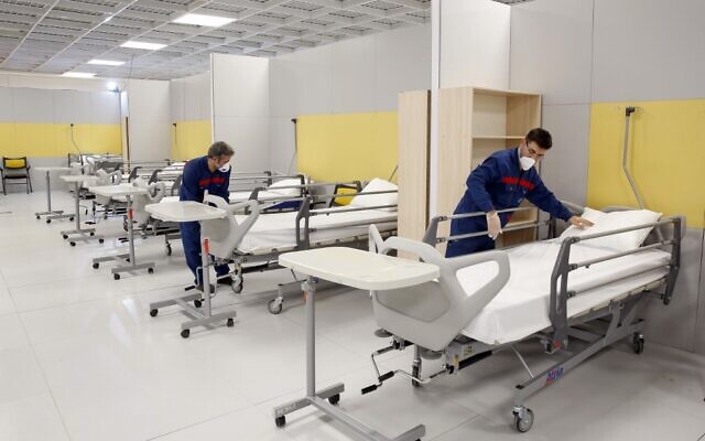Iranian workers set up a makeshift hospital inside the Iran Mall, northwest of Tehran, on March 21, 2020 amid the coronavirus outbreak. (AFP) Iranian workers set up a makeshift hospital inside the Iran Mall, northwest of Tehran, on March 21, 2020 amid the coronavirus outbreak. (AFP)