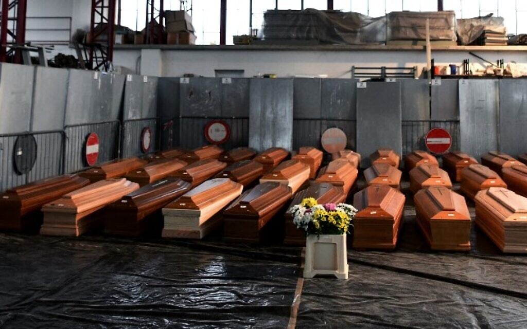A view shows some of 35 coffins of deceased people stored in a warehouse in Ponte San Pietro, near Bergamo, Lombardy, on March 26, 2020 prior to be transported in another region to be cremated. (Piero CRUCIATTI / AFP) A view shows some of 35 coffins of deceased people stored in a warehouse in Ponte San Pietro, near Bergamo, Lombardy, on March 26, 2020 prior to be transported in another region to be cremated. (Piero CRUCIATTI / AFP)