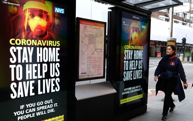 A pedestrian walks past signage about the coronavirus in central London on March 31, 2020, as life in Britain continues during the nationwide lockdown to combat the COVID-19 pandemic. (Photo by Isabel INFANTES / AFP) A pedestrian walks past signage about the coronavirus in central London on March 31, 2020, as life in Britain continues during the nationwide lockdown to combat the COVID-19 pandemic. (Photo by Isabel INFANTES / AFP)