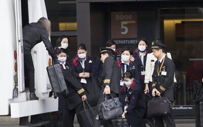 An international airlines crew arrives at the departure gate at SeattleTacoma International Airport (also known as Sea-Tac Airport) on March 8, 2020 in Seattle, Washington. (Karen Ducey/Getty Images/AFP) An international airlines crew arrives at the departure gate at SeattleTacoma International Airport (also known as Sea-Tac Airport) on March 8, 2020 in Seattle, Washington. (Karen Ducey/Getty Images/AFP)