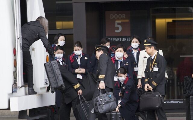 An international airlines crew arrives at the departure gate at SeattleTacoma International Airport (also known as Sea-Tac Airport) on March 8, 2020 in Seattle, Washington. (Karen Ducey/Getty Images/AFP) An international airlines crew arrives at the departure gate at SeattleTacoma International Airport (also known as Sea-Tac Airport) on March 8, 2020 in Seattle, Washington. (Karen Ducey/Getty Images/AFP)