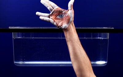 Guy Aon showing his photo developing technology that allows him to place photos on the body, in a kind of flexible body mask (Courtesy Guy Aon)