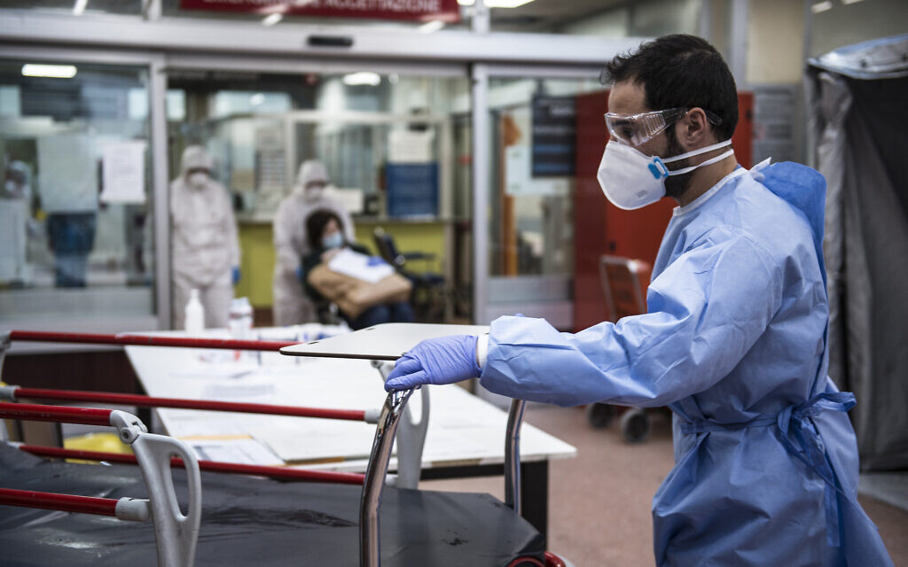 Medical personnel in protective suits await the arrival of possible COVID-19 infections in the Molinette Hospital lobby in Turin, Italy, March 26, 2020. (Stefano Guidi/Getty Images/ via JTA) Medical personnel in protective suits await the arrival of possible COVID-19 infections in the Molinette Hospital lobby in Turin, Italy, March 26, 2020. (Stefano Guidi/Getty Images/ via JTA)