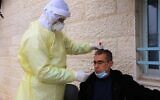 A Palestinian health official carries out a test for coronavirus on a man in Bethlehem on March 31, 2020. (Credit: Wafa)