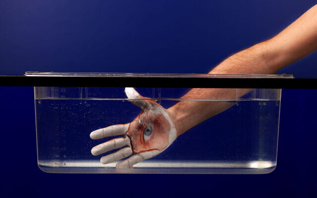 Guy Aon showing his photo developing technology that allows him to place photos on the body, in a kind of flexible body mask (Courtesy Guy Aon)