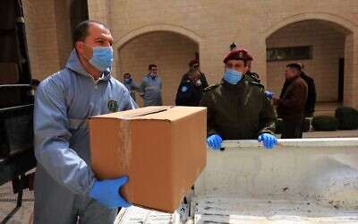 Palestinians bringing meals to quarantined people in Bethlehem on March 15, 2020. (Adam Rasgon/Times of Israel)