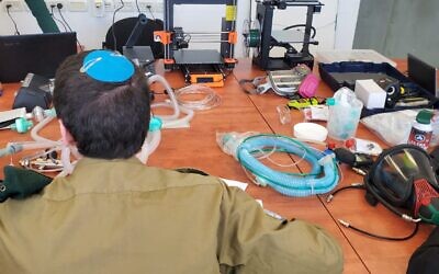 A soldier in Military Intelligence's technology unit works on a project to convert CPAP machines into ventilators to help combat the coronavirus pandemic in March 2020. (Israel Defense Forces)