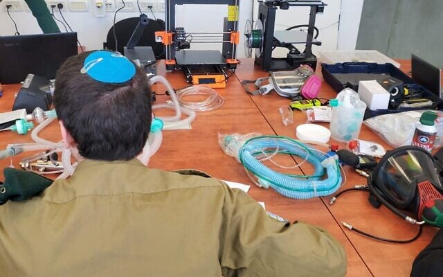 A soldier in Military Intelligence's technology unit works on a project to convert CPAP machines into ventilators to help combat the coronavirus pandemic in March 2020. (Israel Defense Forces) A soldier in Military Intelligence's technology unit works on a project to convert CPAP machines into ventilators to help combat the coronavirus pandemic in March 2020. (Israel Defense Forces)