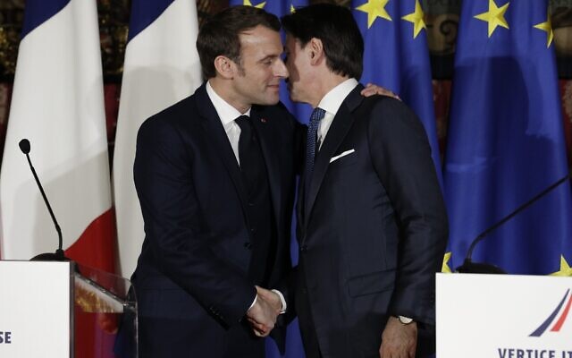 In this February 27, 2020 file photo, French President Emmanuel Macron, left, puts his arm around the shoulder of Italian Premier Giuseppe Conte and gives him a kiss on both cheeks during a joint press conference on the occasion of a French-Italian summit in Naples, southern Italy. (AP Photo/Andrew Medichini, File) In this February 27, 2020 file photo, French President Emmanuel Macron, left, puts his arm around the shoulder of Italian Premier Giuseppe Conte and gives him a kiss on both cheeks during a joint press conference on the occasion of a French-Italian summit in Naples, southern Italy. (AP Photo/Andrew Medichini, File)