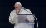 Pope Francis coughs during the Angelus noon prayer he recited from the window of his studio overlooking St. Peter's Square, at the Vatican, March 1, 2020. (AP Photo/Andrew Medichini)
