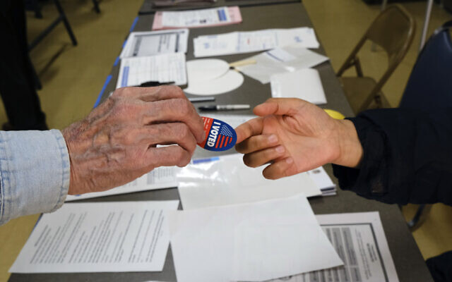Early voter receives his I-Voted sticker, at an early voting polling station at the Ranchito Avenue Elementary School in the Panorama City section of Los Angeles March 2, 2020. (Richard Vogel/AP) Early voter receives his I-Voted sticker, at an early voting polling station at the Ranchito Avenue Elementary School in the Panorama City section of Los Angeles March 2, 2020. (Richard Vogel/AP)