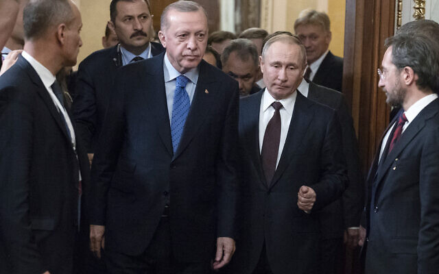 Russian President Vladimir Putin, center right, and Turkish President Recep Tayyip Erdogan, center left, arrive for a news conference after their talks in the Kremlin, in Moscow, Russia, Thursday, March 5, 2020. Russian President Vladimir Putin and his Turkish counterpart, Recep Tayyip Erdogan, say they have reached agreements that could end fighting in northwestern Syria. (AP Photo/Pavel Golovkin, Pool) Russian President Vladimir Putin, center right, and Turkish President Recep Tayyip Erdogan, center left, arrive for a news conference after their talks in the Kremlin, in Moscow, Russia, Thursday, March 5, 2020. Russian President Vladimir Putin and his Turkish counterpart, Recep Tayyip Erdogan, say they have reached agreements that could end fighting in northwestern Syria. (AP Photo/Pavel Golovkin, Pool)