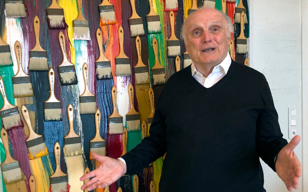 In this photo taken on Monday, March 2, 2020, billionaire art dealer David Nahmad poses in front of a colorful work by French-born American artist Arman, in Nahmad's home in Monaco. (AP Photo/John Leicester) In this photo taken on Monday, March 2, 2020, billionaire art dealer David Nahmad poses in front of a colorful work by French-born American artist Arman, in Nahmad's home in Monaco. (AP Photo/John Leicester)