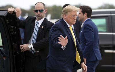 US President Donald Trump waves as he boards Air Force One at Orlando Sanford International Airport, March 9, 2020 in Orlando, Florida. (AP Photo/Alex Brandon)