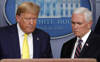 US President Donald Trump steps from the podium to allow Vice President Mike Pence to speak in the briefing room of the White House in Washington, March, 9, 2020, about the coronavirus outbreak. (AP Photo/Carolyn Kaster)