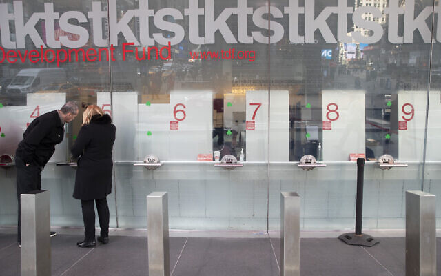 Empty ticket selling booths are seen as a couple buys discounted Broadway theater tickets at the TKTS kiosk, March 11, 2020, in New York's Times Square. (AP Photo/Mary Altaffer) Empty ticket selling booths are seen as a couple buys discounted Broadway theater tickets at the TKTS kiosk, March 11, 2020, in New York's Times Square. (AP Photo/Mary Altaffer)