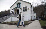 In this Feb. 28, 2020 file photo, Mayor David Depretis of Baldwin Borough brings in the sign announcing 'Fish Fry Today,' after Holy Angels parish sold out of fish in Pittsburgh, Pa. The parish church prepares 2,000 pounds of fish and often sells out early, according to organizer Cindy Depretis, who is married to the mayor. On March 12, Pittsburgh Bishop David Zubik suggested that people enjoy the fish fries with a take-out order rather than dining in due to virus concerns. (AP Photo/Rebecca Droke)