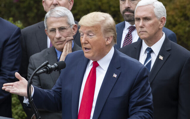 US President Donald Trump, accompanied by Dr. Anthony Fauci, director of the National Institute of Allergy and Infectious Diseases, left, and Vice President Mike Pence, right, speaks during a news conference about the coronavirus in the Rose Garden at the White House, Friday, March 13, 2020, in Washington. (AP/Alex Brandon) US President Donald Trump, accompanied by Dr. Anthony Fauci, director of the National Institute of Allergy and Infectious Diseases, left, and Vice President Mike Pence, right, speaks during a news conference about the coronavirus in the Rose Garden at the White House, Friday, March 13, 2020, in Washington. (AP/Alex Brandon)