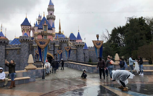 Visitors take photos at Disneyland in Anaheim, Calif., Friday, March 13, 2020. Disneyland is closing its doors for the rest of the month, shuttering one of California's best-known attractions as the state hurries to stop the spread of the coronavirus. (AP/Amy Taxin) Visitors take photos at Disneyland in Anaheim, Calif., Friday, March 13, 2020. Disneyland is closing its doors for the rest of the month, shuttering one of California's best-known attractions as the state hurries to stop the spread of the coronavirus. (AP/Amy Taxin)