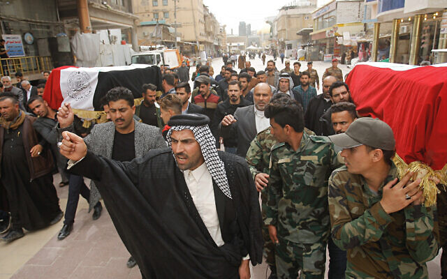 Mourners carry the flag-draped coffins of two fighters of the Popular Mobilization Forces who were killed during US attacks in Iraq, during their funeral procession at the Imam Ali shrine in Najaf, Iraq, March 14, 2020. (AP Photo/Anmar Khalil) Mourners carry the flag-draped coffins of two fighters of the Popular Mobilization Forces who were killed during US attacks in Iraq, during their funeral procession at the Imam Ali shrine in Najaf, Iraq, March 14, 2020. (AP Photo/Anmar Khalil)
