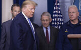 US President Donald Trump arrives to speak, with Dr. Anthony Fauci, director of the National Institute of Allergy and Infectious Diseases, center, and Adm. Brett Giroir, M.D., Assistant Secretary for Health, during a briefing about the coronavirus in the James Brady Press Briefing Room of the White House, March 15, 2020, in Washington. (AP Photo/Alex Brandon)