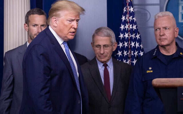 US President Donald Trump arrives to speak, with Dr. Anthony Fauci, director of the National Institute of Allergy and Infectious Diseases, center, and Adm. Brett Giroir, M.D., Assistant Secretary for Health, during a briefing about the coronavirus in the James Brady Press Briefing Room of the White House, March 15, 2020, in Washington. (AP Photo/Alex Brandon) US President Donald Trump arrives to speak, with Dr. Anthony Fauci, director of the National Institute of Allergy and Infectious Diseases, center, and Adm. Brett Giroir, M.D., Assistant Secretary for Health, during a briefing about the coronavirus in the James Brady Press Briefing Room of the White House, March 15, 2020, in Washington. (AP Photo/Alex Brandon)