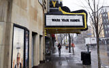 The Varsity Theater, home to concerts, used the marquee to address the need for washing hands due to the coronavirus, the disease that is caused by the new coronavirus, March 16, 2020 near the University of Minnesota in Minneapolis. (AP Photo/Jim Mone)