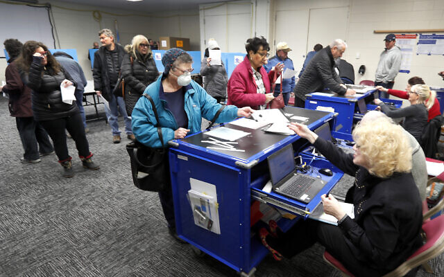 Chicago residents line up for early voting at the Roden Library Monday, March 16, 2020, in Chicago. (AP Photo/Charles Rex Arbogast) Chicago residents line up for early voting at the Roden Library Monday, March 16, 2020, in Chicago. (AP Photo/Charles Rex Arbogast)