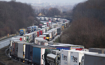 Trucks are jammed on the motorway A4  near Bautzen, Germany, Tuesday, March 17, 2020. Because of the controls at the border with Poland, a traffic jam formed on the Autobahn 4 between Dresden and Goerlitz, which, according to police, had grown to a length of 40 kilometers by noon.  (Robert Michael/dpa via AP)
