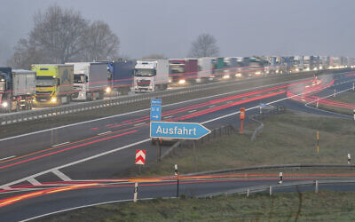 Trucks are jammed in the early morning on Autobahn 12 in front of the German-Polish border crossing near Frankfurt (Oder), Germany, March 18, 2020. (Patrick Pleul/dpa via AP)