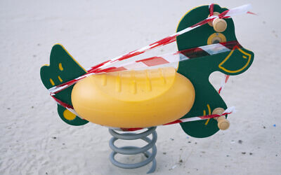 This March 19, 2020 photo, shows a playground toy at Tel Aviv's beachfront wrapped in tape to prevent use. (AP Photo/Oded Balilty)