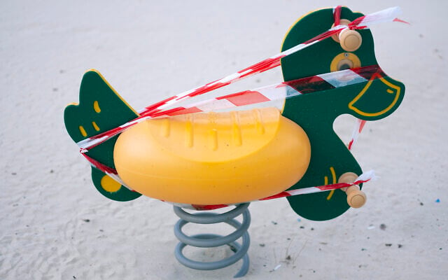 This March 19, 2020 photo, shows a playground toy at Tel Aviv's beachfront wrapped in tape to prevent use. (AP Photo/Oded Balilty) This March 19, 2020 photo, shows a playground toy at Tel Aviv's beachfront wrapped in tape to prevent use. (AP Photo/Oded Balilty)