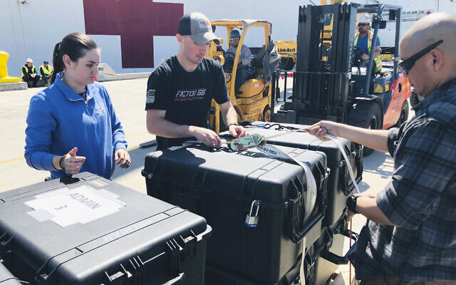 US Navy sailors prepare pallets of supplies to be loaded aboard the Military Sealift Command hospital ship USNS Mercy (T-AH 19) at Naval Base San Diego, adjacent to San Diego, California, Saturday, March 21, 2020. Mercy is preparing to deploy in support of the nation's COVID-19 response efforts and will serve as a referral hospital for non-COVID-19 patients currently admitted to shore-based hospitals. (Senior Chief Mass Communication Specialist Mike Jones/U.S. Navy via AP) US Navy sailors prepare pallets of supplies to be loaded aboard the Military Sealift Command hospital ship USNS Mercy (T-AH 19) at Naval Base San Diego, adjacent to San Diego, California, Saturday, March 21, 2020. Mercy is preparing to deploy in support of the nation's COVID-19 response efforts and will serve as a referral hospital for non-COVID-19 patients currently admitted to shore-based hospitals. (Senior Chief Mass Communication Specialist Mike Jones/U.S. Navy via AP)