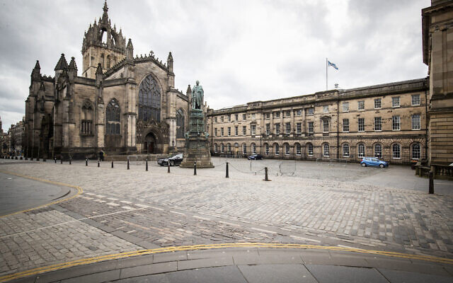 This photo shows the Royal Mile, part of the Old Town of Edinburgh, Scotland, Britain, Saturday, March 21, 2020, on the first day after Prime Minister Boris Johnson ordered pubs and restaurants across the country to close as the government announced measures to cover the wages of workers who would otherwise lose their jobs due to the coronavirus outbreak. (Jane Barlow/PA via AP) This photo shows the Royal Mile, part of the Old Town of Edinburgh, Scotland, Britain, Saturday, March 21, 2020, on the first day after Prime Minister Boris Johnson ordered pubs and restaurants across the country to close as the government announced measures to cover the wages of workers who would otherwise lose their jobs due to the coronavirus outbreak. (Jane Barlow/PA via AP)