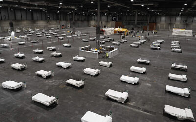 In this photo provided by Comunidad de Madrid, beds for COVID-19 patients are placed at IFEMA convention center in Madrid, Spain on March 21, 2020. (Comunidad de Madrid via AP)