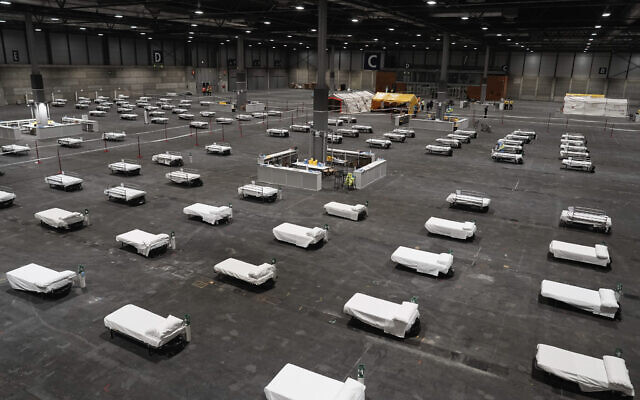 In this photo provided by Comunidad de Madrid, beds for COVID-19 patients are placed at IFEMA convention center in Madrid, Spain on March 21, 2020. (Comunidad de Madrid via AP) In this photo provided by Comunidad de Madrid, beds for COVID-19 patients are placed at IFEMA convention center in Madrid, Spain on March 21, 2020. (Comunidad de Madrid via AP)
