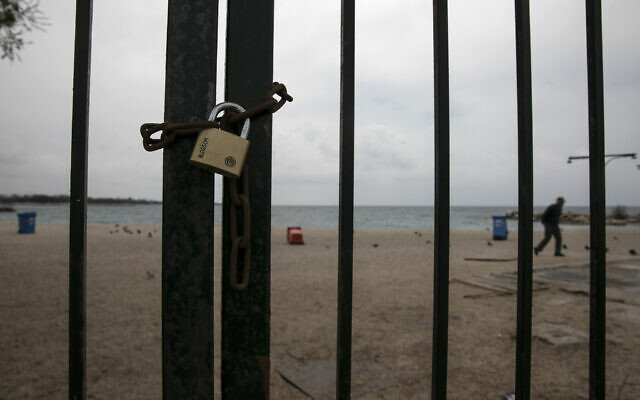 A padlock is seen on the entrance of a beach at the Alimos suburb of Athens, Sunday, March 22, 2020. Schools, restaurants, and other public places are already closed in the Greek capital aimed at slowing the spread of the new coronavirus, but other places like supermarkets, pharmacies and gas stations remain open. (AP Photo/Yorgos Karahalis) A padlock is seen on the entrance of a beach at the Alimos suburb of Athens, Sunday, March 22, 2020. Schools, restaurants, and other public places are already closed in the Greek capital aimed at slowing the spread of the new coronavirus, but other places like supermarkets, pharmacies and gas stations remain open. (AP Photo/Yorgos Karahalis)