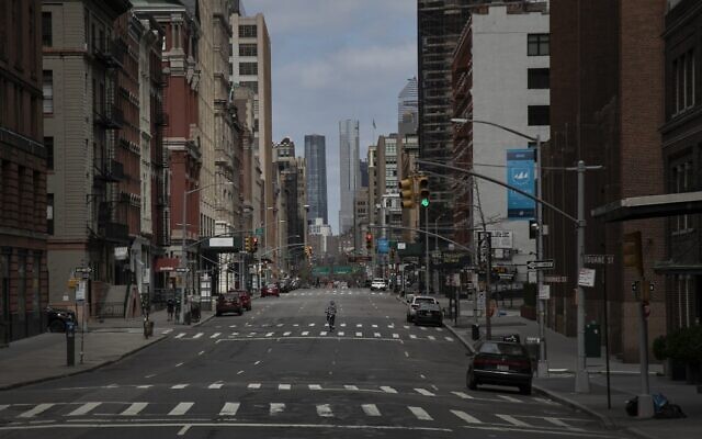 A cyclist rides his bicycle down the middle of a main road in downtown New York, March 22, 2020. (Wong Maye-E/AP) A cyclist rides his bicycle down the middle of a main road in downtown New York, March 22, 2020. (Wong Maye-E/AP)