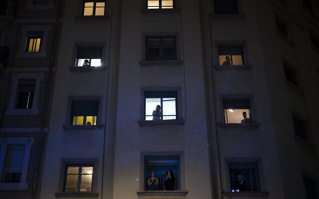 People applaud from their window in support of the medical staff working on the COVID-19 virus outbreak in Barcelona, Spain, Monday, March 23, 2020. (AP Photo/Felipe Dana) People applaud from their window in support of the medical staff working on the COVID-19 virus outbreak in Barcelona, Spain, Monday, March 23, 2020. (AP Photo/Felipe Dana)