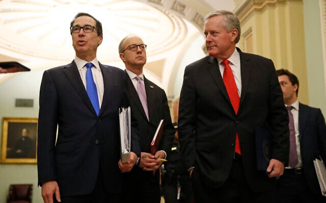 US Treasury Secretary Steven Mnuchin, left, accompanied by White House Legislative Affairs Director Eric Ueland and acting White House chief of staff Mark Meadows, speaks with reporters as he walks to the offices of Senate Majority Leader Mitch McConnell on Capitol Hill in Washington, March 24, 2020. (AP Photo/Patrick Semansky) US Treasury Secretary Steven Mnuchin, left, accompanied by White House Legislative Affairs Director Eric Ueland and acting White House chief of staff Mark Meadows, speaks with reporters as he walks to the offices of Senate Majority Leader Mitch McConnell on Capitol Hill in Washington, March 24, 2020. (AP Photo/Patrick Semansky)