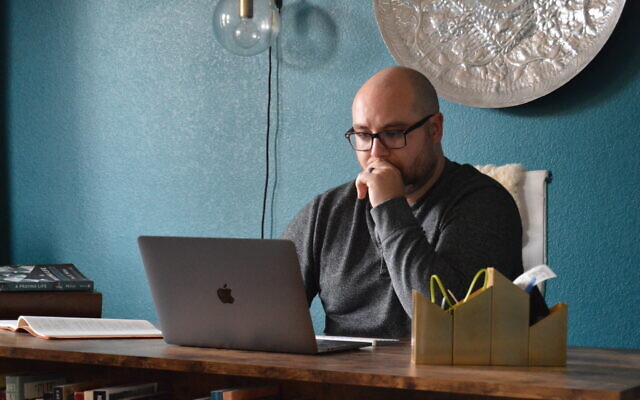 In this photo provided by Brett Seidl, Jonathon Seidl sits in his home office in Dallas on March 18, 2020 (Brett Seidl via AP) In this photo provided by Brett Seidl, Jonathon Seidl sits in his home office in Dallas on March 18, 2020 (Brett Seidl via AP)