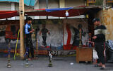 In this Thursday, March 19, 2020 photo, a man smokes waterpipe at Tahrir square, Baghdad, Iraq (AP Photo/Khalid Mohammed)