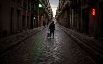 A man walks along an empty street in downtown Barcelona, Spain, March 26, 2020 as a lockdown to combat the spread of coronavirus continues. (AP Photo/Emilio Morenatti) A man walks along an empty street in downtown Barcelona, Spain, March 26, 2020 as a lockdown to combat the spread of coronavirus continues. (AP Photo/Emilio Morenatti)