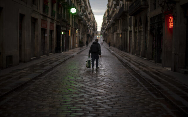 A man walks along an empty street in downtown Barcelona, Spain, March 26, 2020 as a lockdown to combat the spread of coronavirus continues. (AP Photo/Emilio Morenatti) A man walks along an empty street in downtown Barcelona, Spain, March 26, 2020 as a lockdown to combat the spread of coronavirus continues. (AP Photo/Emilio Morenatti)