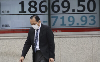 A man walks by an electronic stock board of a securities firm in Tokyo, March 30, 2020. (AP Photo/Koji Sasahara) A man walks by an electronic stock board of a securities firm in Tokyo, March 30, 2020. (AP Photo/Koji Sasahara)