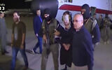 In this frame grab from Egyptian State Television, a blindfolded Hisham el-Ashmawi is escorted by Egyptian military officers and placed in a vehicle after being taken off a military plane at an airport in Cairo, Egypt, May 29, 2019 (Egyptian State Television via AP)