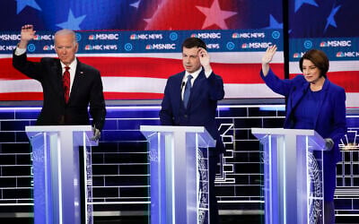 Former US vice president Joe Biden, from left, former South Bend Mayor Pete Buttigieg, Minnesota Senator Amy Klobuchar gesture during a Democratic presidential primary debate on February 19, 2020, in Las Vegas, hosted by NBC News and MSNBC. (AP Photo/John Locher)