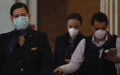El Al employees wearing protective masks arrive  in Ben Gurion airport near Tel Aviv, Israel, Thursday, Feb. 27, 2020. (AP/Ariel Schalit)