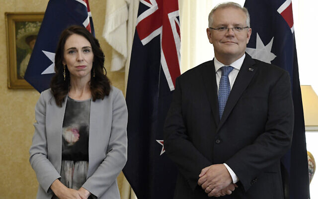 Illustrative: New Zealand Prime Minister Jacinda Ardern, left, stands with Australian Prime Minister Scott Morrison during the signing of the Indigenous Collaboration Arrangement at Admiralty House in Sydney, February 28, 2020. (Bianca De Marchi/Pool Photo via AP) Illustrative: New Zealand Prime Minister Jacinda Ardern, left, stands with Australian Prime Minister Scott Morrison during the signing of the Indigenous Collaboration Arrangement at Admiralty House in Sydney, February 28, 2020. (Bianca De Marchi/Pool Photo via AP)